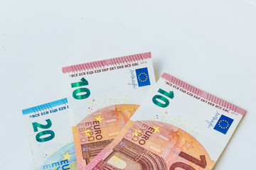 Three Euro banknotes laying on the pure white background