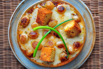 French Onion Soup rich beef broth with caramelized Pearl Onions, Swiss Cheese and Red Pepper Flake Croutons