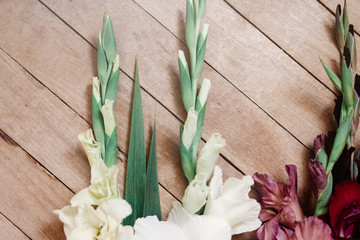 beautiful gladiolus in different colors flowers on wooden rustic background, arrangement concept, amazing wallpaper