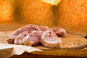 Fresh raw pork chops on a cutting board. Arrangement on the wrapping paper