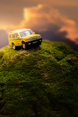 Four by four off road car crossing through  the mountain covered with green moss. Travel and racing concept for four wheel drive off road vehicle .