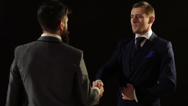 Two business men shake hands in sign of the contract. Two colleagues handshaking after meeting. A successful contract.