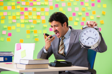 Businessman with many conflicting priorities in time management 