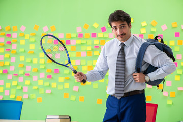 Man with tennis racket in the office with many conflicting prior
