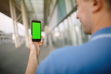 Cropped shot view of a man's hands holding cell telephone,
