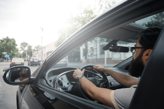 Modern Casual Bearded Man Driving A Car