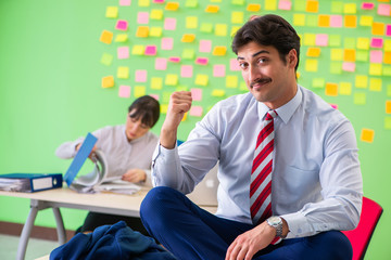 Fototapeta premium Man and woman in the office with many conflicting priorities in 