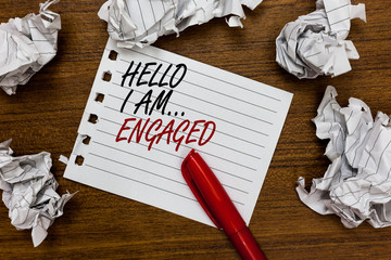 Conceptual hand writing showing Hello I Am... Engaged. Business photo showcasing He gave the ring We are going to get married Wedding Written white page touched red marker scattered paper lump.