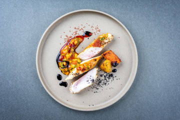 Modern style barbecue crocodile tail eye fillet with roasted sweet potatoes pineapples and mango...