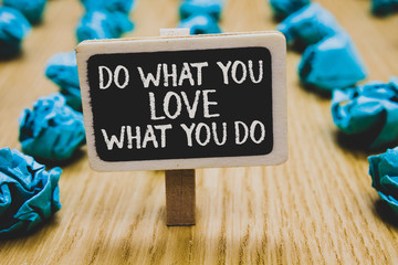 Handwriting text writing Do What You Love What You Do. Concept meaning Make things that motivate yourself Passion Stand blackboard with white words behind blurry blue paper lobs woody floor.