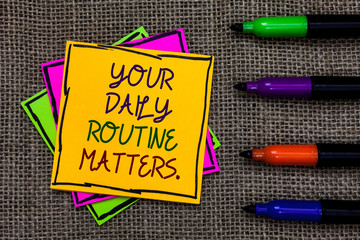 Text sign showing Your Daily Routine Matters. Conceptual photo Have good habits to live a healthy life Written on some colorful sticky note 4 pens laid in rank on jute base.