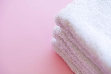 Spa. White Cotton Towels Use In Spa Bathroom on Pink Background. Towel Concept. Photo For Hotels and Massage Parlors. Purity and Softness. Towel Textile