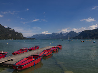 Boats in the lake in front of mountain scenery