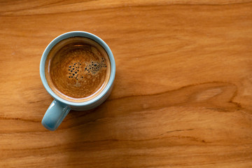 hot coffee isolated on wood background.espresso coffee cup top view.