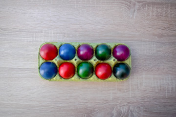 Color Easter Eggs on Wooden Background