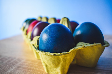 Color Easter Eggs on Wooden Background