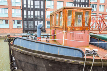 Fototapeta na wymiar Gloucester, United Kingdom - March 28, 2015: An overcast SPring day in Gloucester in the West Country of England are the Gloucester Docks with various boats and barges.