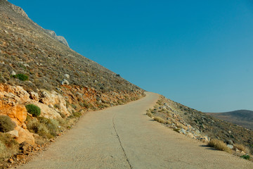 Idylic west Crete landscape with goats countryside road in summertime season, Greece