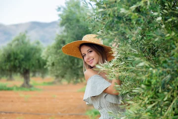 Photo sur Plexiglas Olivier Young redhead girl wearing in dress and hat have a rest in greek olive garden in Heraklion, Crete, Greece