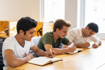 International company employees taking refresh training. Multiethnic group of three students...
