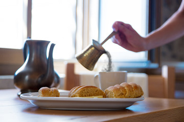 Traditional Crete breakfast, bread, cheese and coffee on wooden table on a kitchen. Crete, Greece