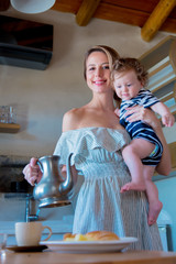 True family. Mother and little boy on kitchen preparing a breakfast