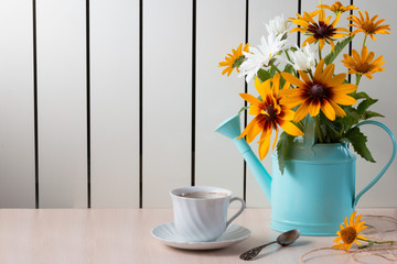 Bouquet of summer flowers like heliopsis, chamomile, rudbeckia and gaillardia in watering can