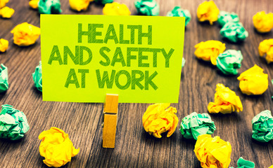Handwriting text Health And Safety At Work. Concept meaning Secure procedures prevent accidents avoid danger Paperclip retain written words yellow paper paper lobs laid on wooden floor.