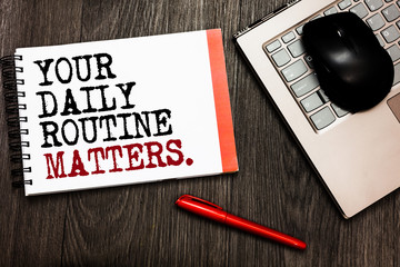 Conceptual hand writing showing Your Daily Routine Matters. Business photo showcasing Have good habits to live a healthy life Bluetooth mouse on keyboard words red pen on wooden deck.