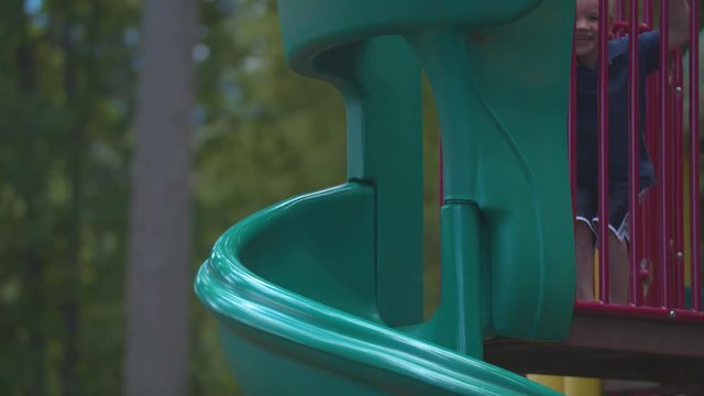 A boy playing on the top of a slide and eventually going down.  Shot on a Blackmagic Ursa Mini Pro 4.6k with a Sigma 50-100mm f/1.8.