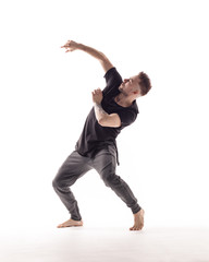 Young beautiful dancer is posing in studio