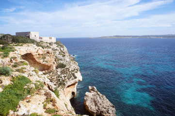 Fototapeta na wymiar Saint Mary's Battery on Comino, Malta with cliffs and the blue sea on sunny day