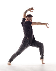 Young beautiful dancer is posing in studio