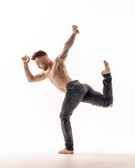 Young beautiful dancer is posing in studio