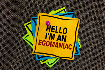Text sign showing Hello I am An Egomaniac. Conceptual photo Selfish Egocentric Narcissist Self-centered Ego Black bordered different color sticky note stick together with pin on jute sack.