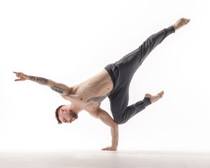 Young beautiful dancer is posing in studio