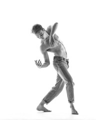 Young beautiful dancer is posing in studio