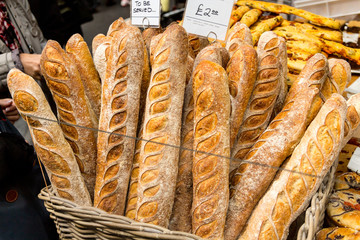 London, United Kingdom - May 2, 2015: Various loaves of breads piled up on a martket stall in Borough Market, London waiting for purchase.