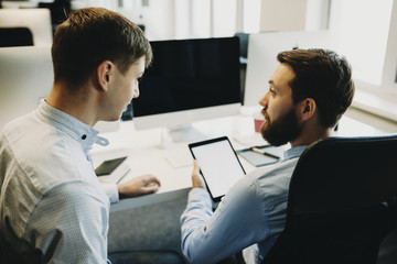 Coworkers with tablet in office