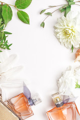 Stylish women's accessories and delicate flowers, top view