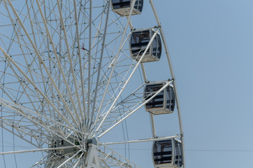 big wheel in the seaside village, in the background clean blue sky