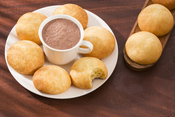 Almojabana, traditional Colombian food - Drink of chocolate. Top view