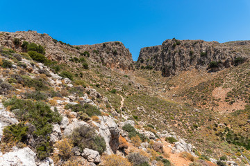 Fototapeta na wymiar Vreiko Cave Pass Lasithi Makrigialos mountains wonderland tour, steep slopes, rocky peaks for hiking adventure recreation sports in Crete, Greece.