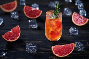 Refreshing cocktail with ice grapefruit and rosemary.Top view