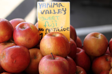 Fresh Fuji apples at a farmer's market.
