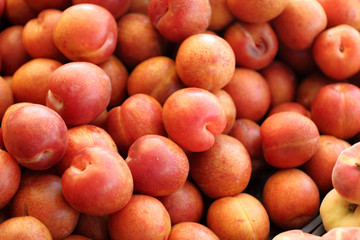Pile of organic plums at the market.