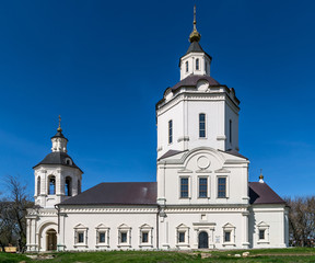 Fototapeta na wymiar Ancient church with white walls against the blue sky