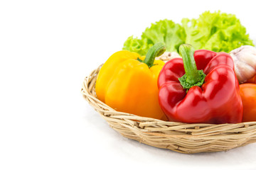 Organic vegetables in the wicker basket on white background