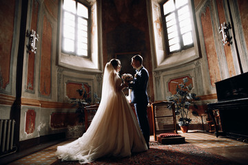 Bride and groom in the Church.Beautiful wedding photos of a couple.Couple in love.Wedding dress and...
