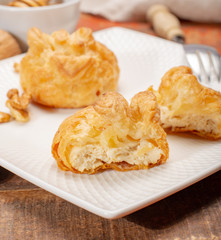 French snack pouches made from puff pastry with fresh soft goat cheese and honing